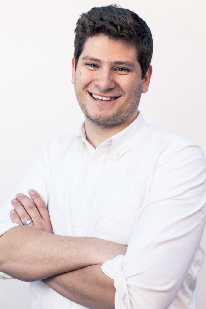 Portrait of Travis Harley, Founder and CEO of Conch LLC, smiling with arms crossed